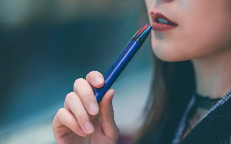 Woman Holding Blue Vape pen