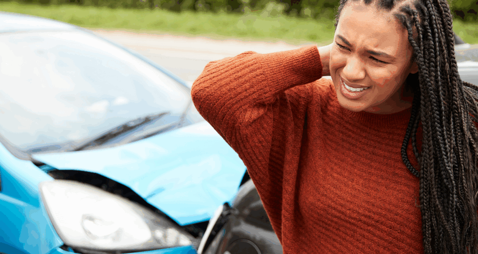 Woman grabbing neck in pain after a car accident