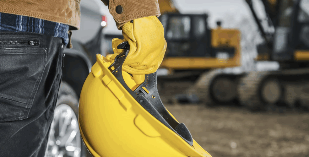 Screenshot 2025-10-07 at 1.48.55 PM Man holding hardhat on job site